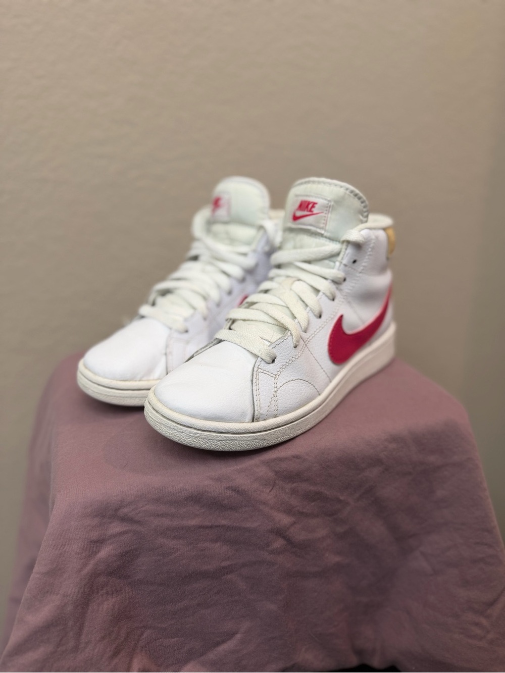 Nike White High-Top Sneakers with Pink Swoosh and Subtle Yellow Heel Tab